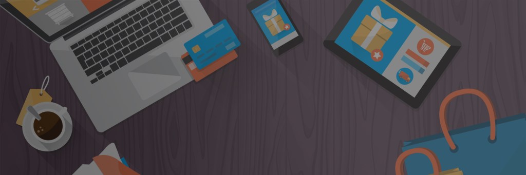 computer and tablet with work related items on a table